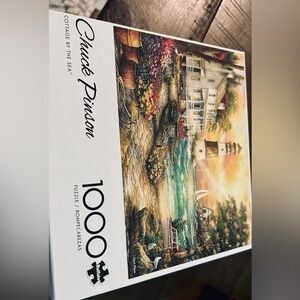 Four 1000 piece and one 750 piece puzzles. All pieces in tact. 2/Thomas Kinkade